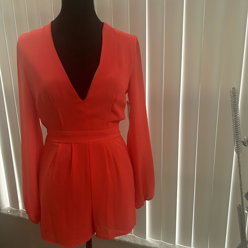 Charlotte Russe Coral Long Sleeve Romper The color is CORAL
